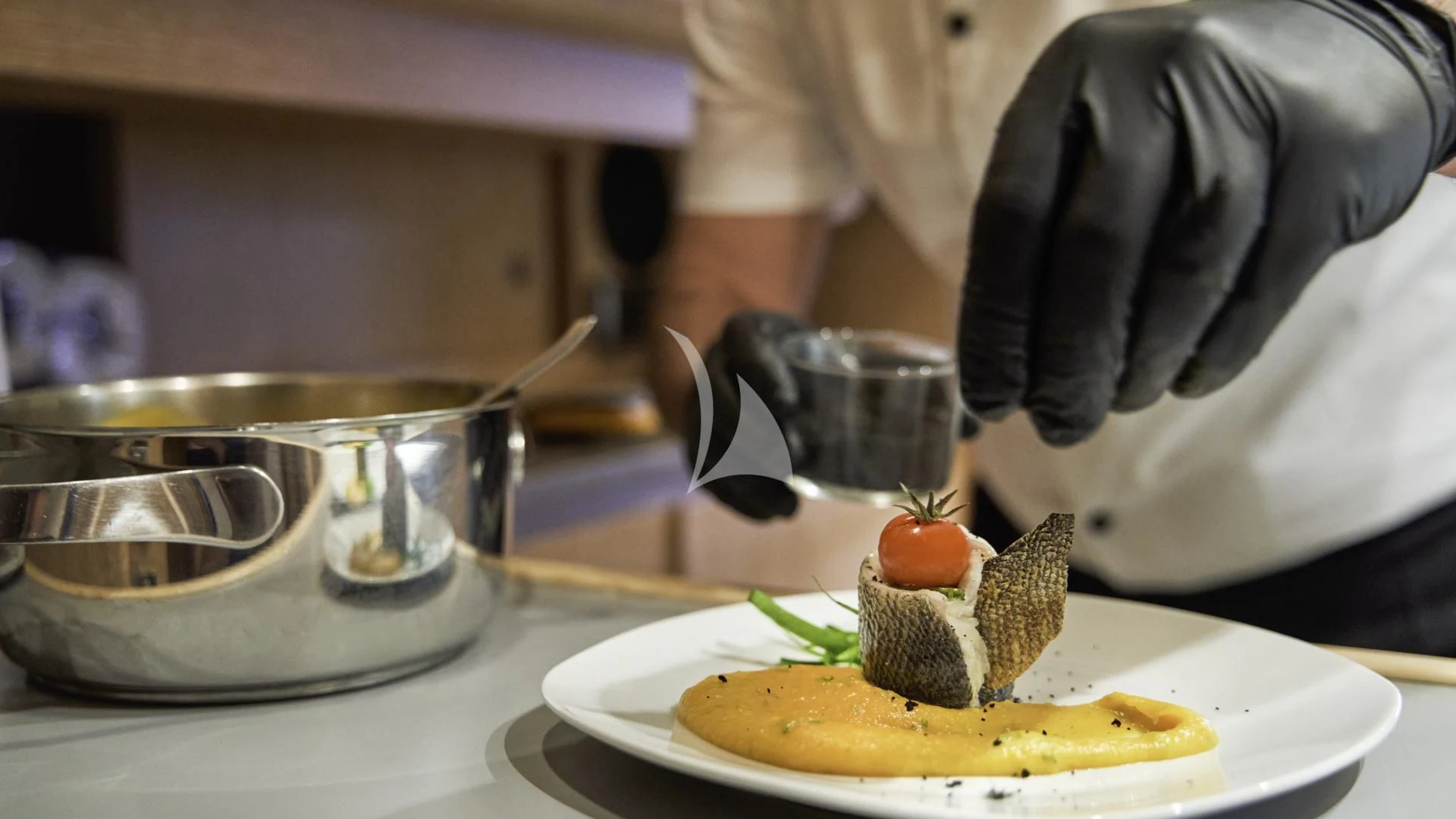 a person putting a piece of cake on a plate aboard ACCEPTUS Yacht for Sale