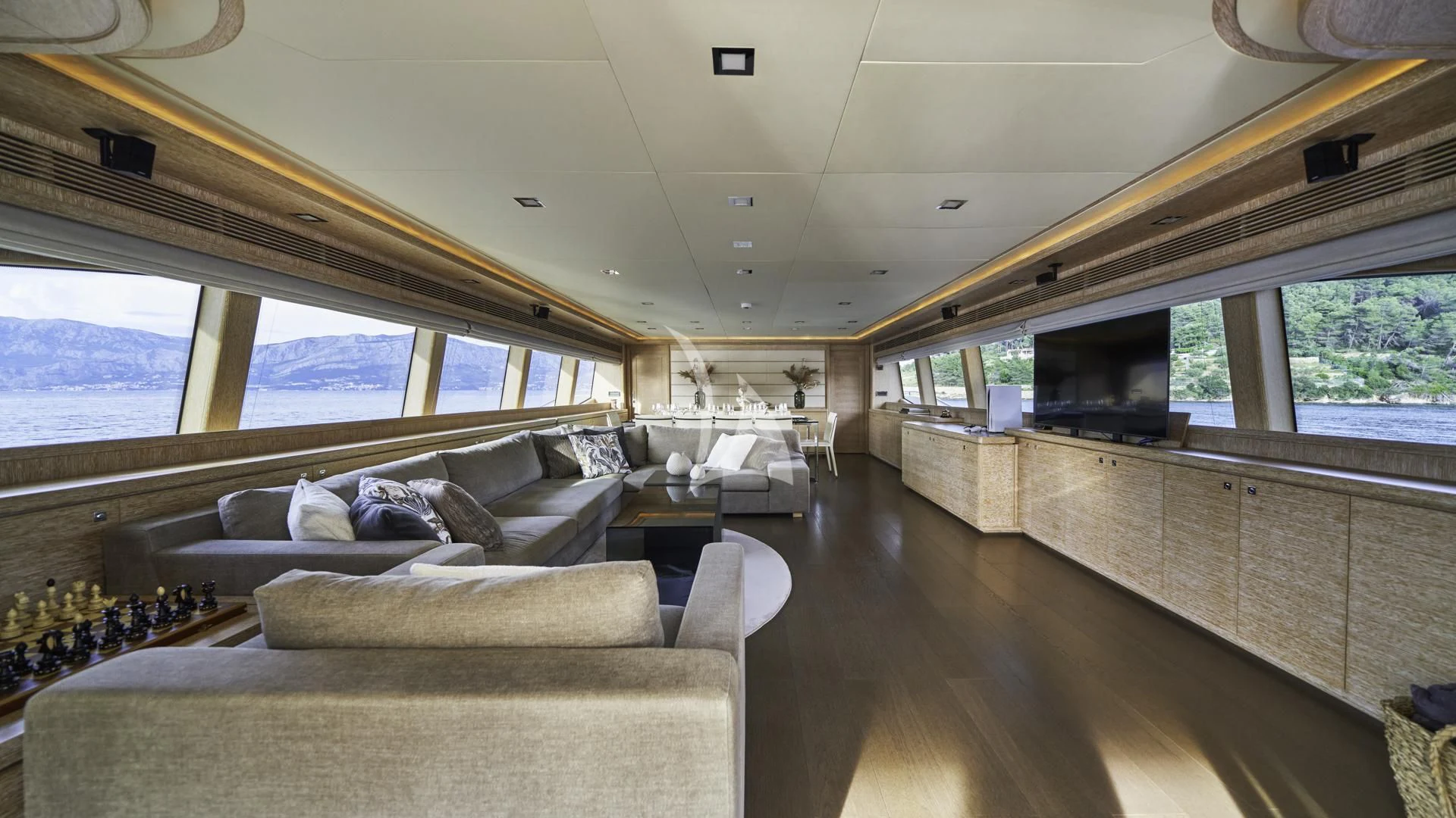 a room with couches and a television aboard ACCEPTUS Yacht for Sale