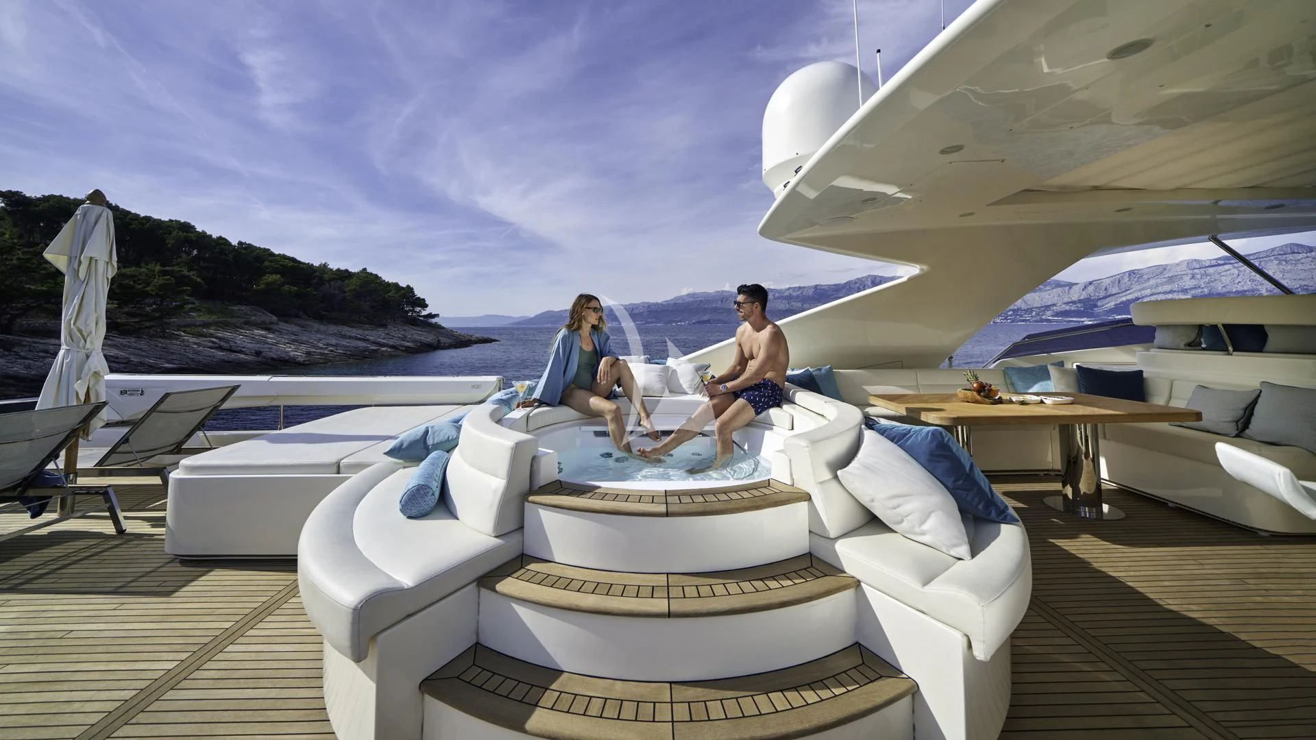 a couple of people sitting on a boat in the water aboard ACCEPTUS Yacht for Sale