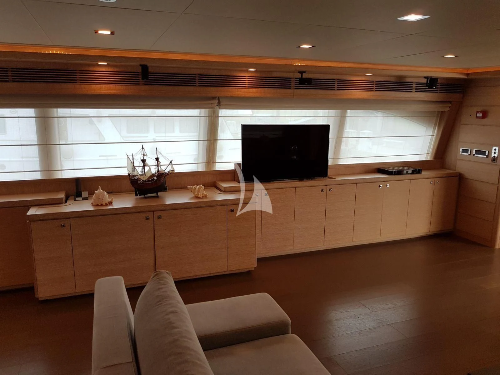 a room with white cabinets and a tv on the wall aboard ACCEPTUS Yacht for Sale
