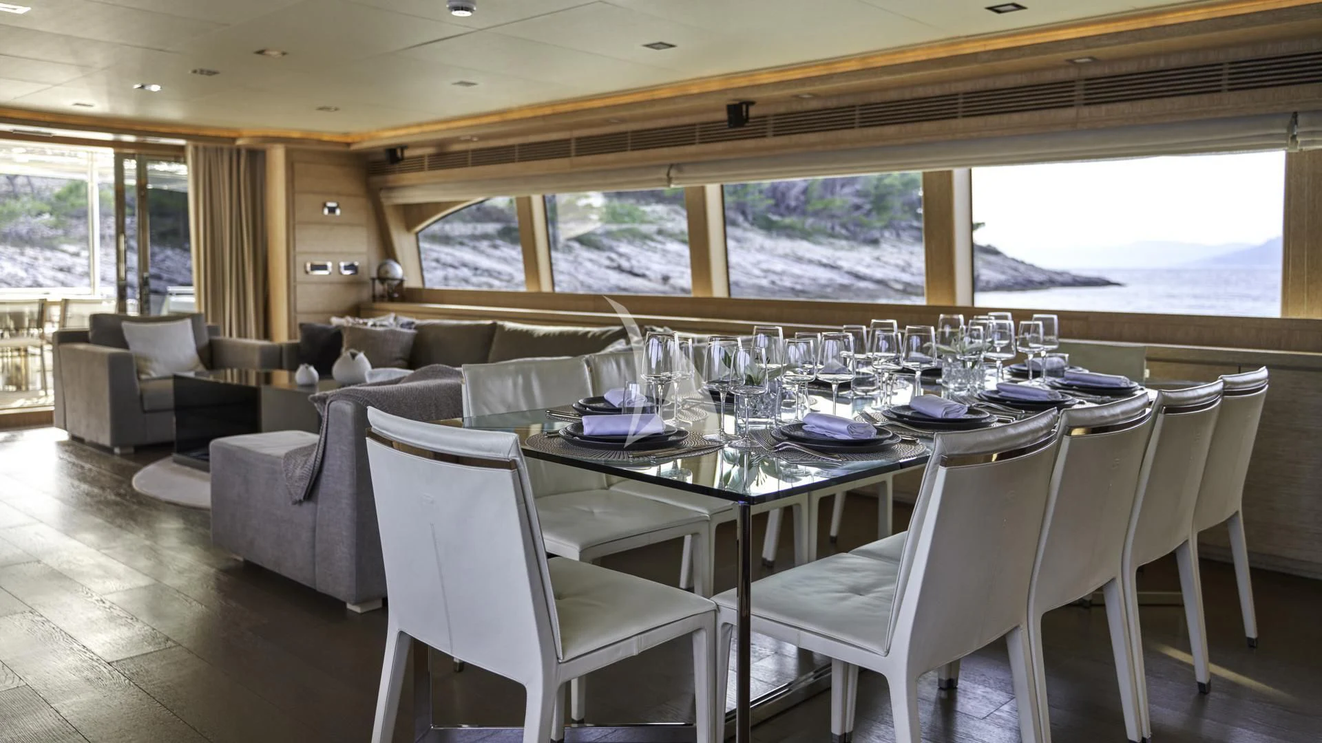 a dining room with a large window aboard ACCEPTUS Yacht for Sale