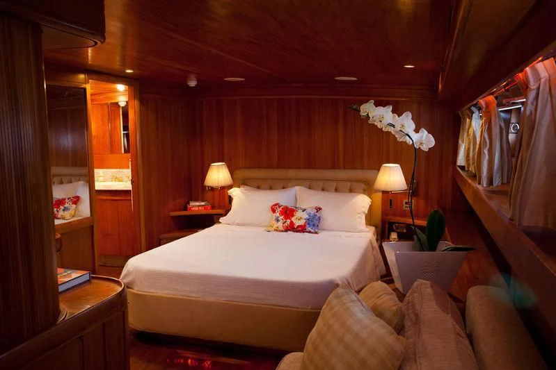 a hotel room with a bed and a couch aboard TAMARIND Yacht for Sale