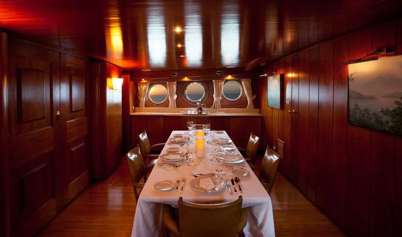 a dining table in a restaurant aboard TAMARIND Yacht for Sale