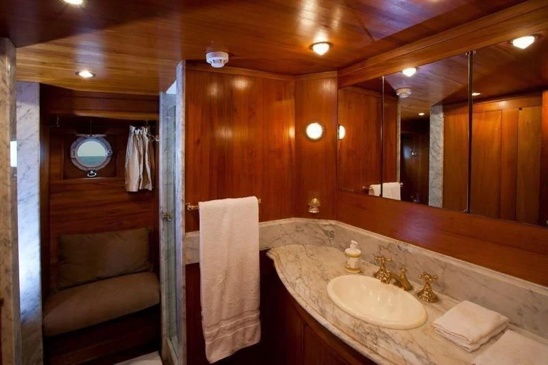 a bathroom with a sink and a mirror aboard TAMARIND Yacht for Sale