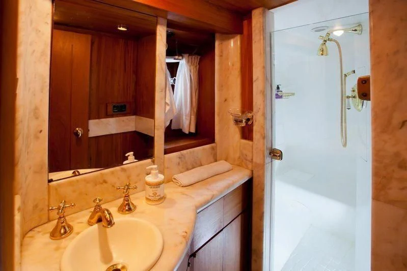 a bathroom with a sink and a shower aboard TAMARIND Yacht for Sale