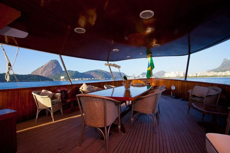 a table and chairs on a deck aboard TAMARIND Yacht for Sale