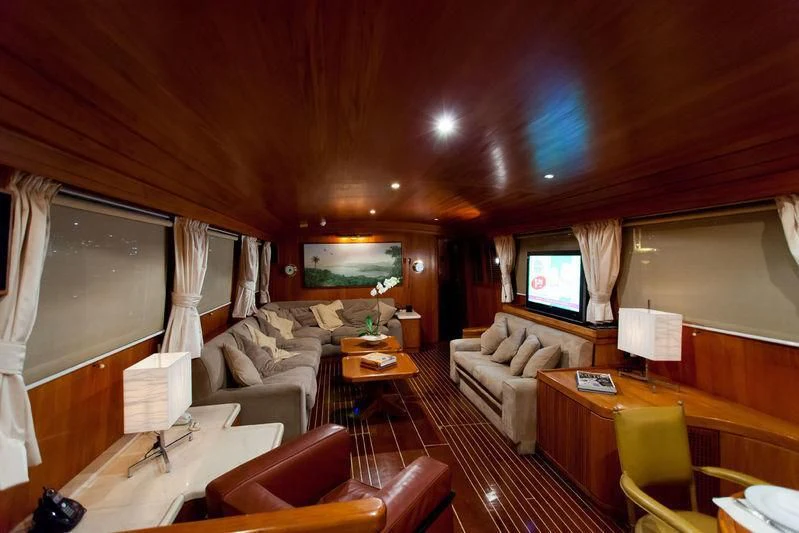 a living room with a couch and a television aboard TAMARIND Yacht for Sale