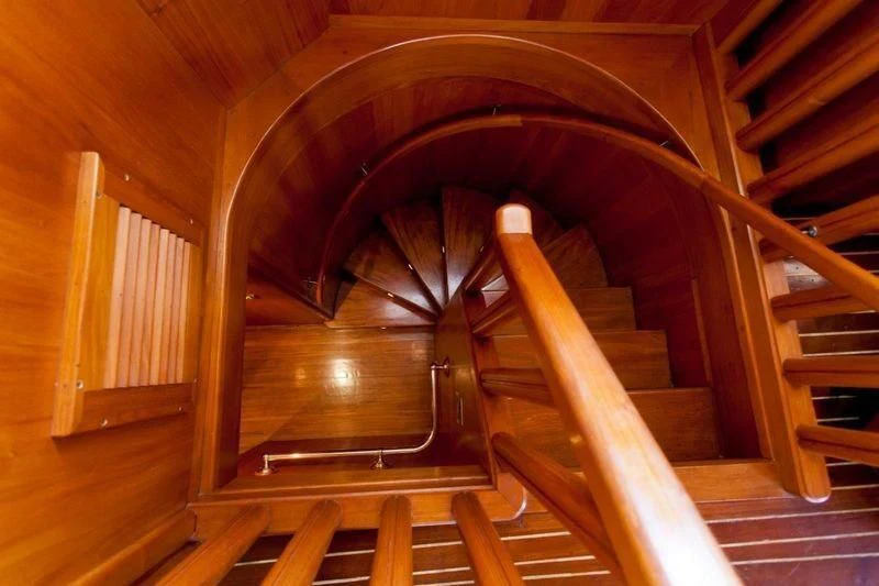a staircase with wooden railings aboard TAMARIND Yacht for Sale