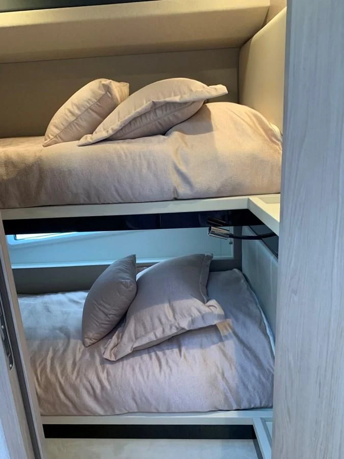 a bed with a blue blanket aboard IMAGINE Yacht for Sale