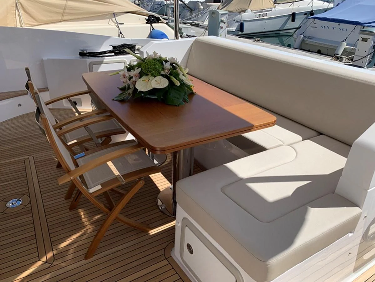 a table with flowers on it aboard IMAGINE Yacht for Sale