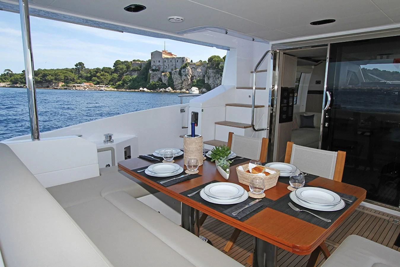 a table with plates and glasses on it aboard IMAGINE Yacht for Sale