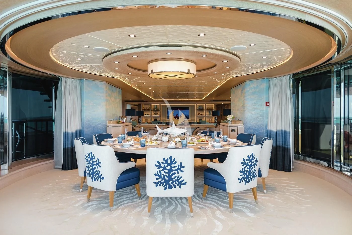 a large room with a table and chairs aboard STARBURST IV Yacht for Charter