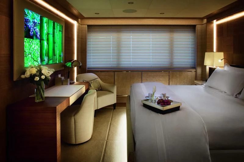 a room with a bed and a desk aboard STARBURST IV Yacht for Charter