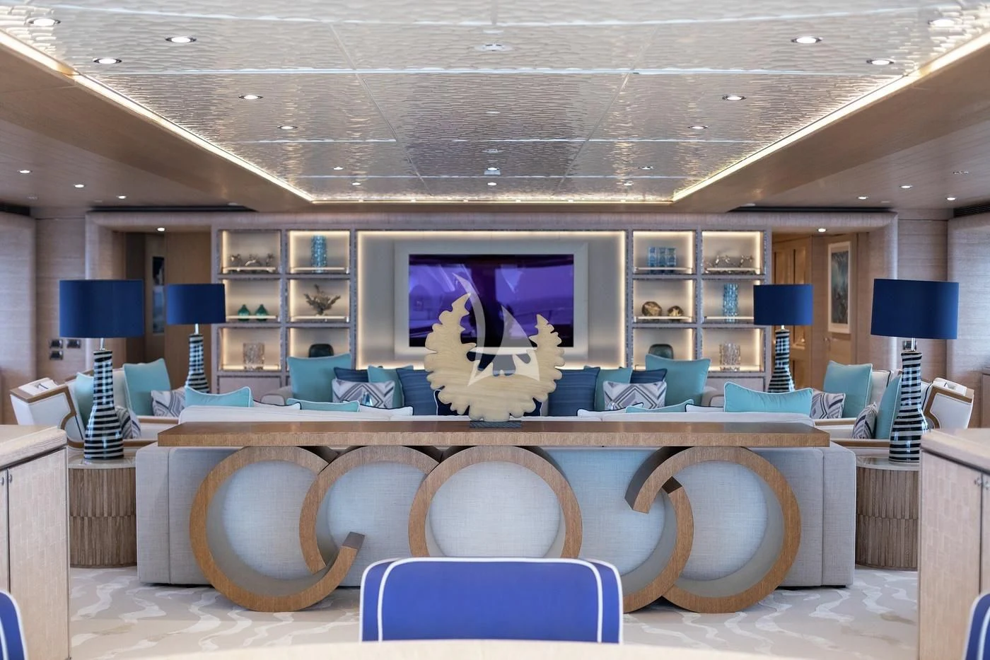 a room with a bench and a table with chairs aboard STARBURST IV Yacht for Charter