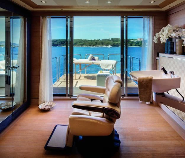 a room with a table chairs and a large window aboard STARBURST IV Yacht for Charter