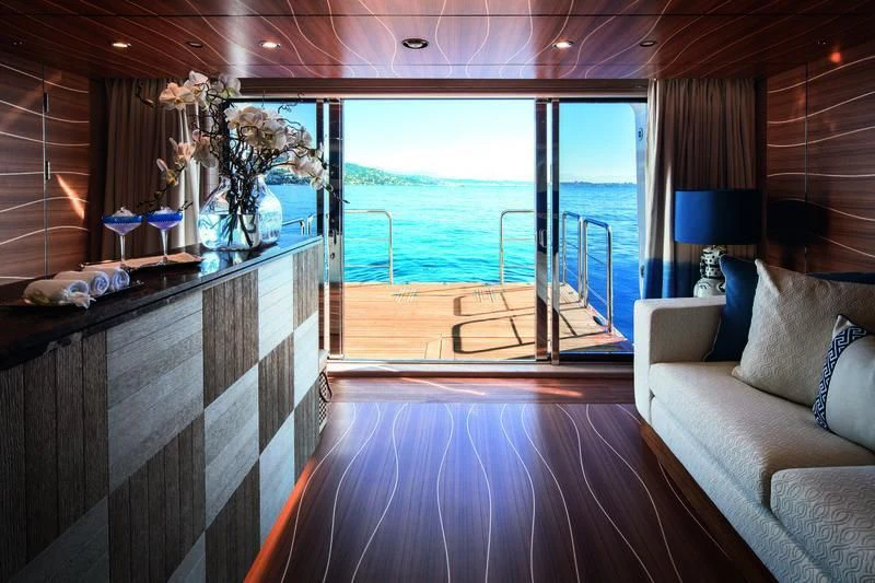 a room with a bed and a large window aboard STARBURST IV Yacht for Charter