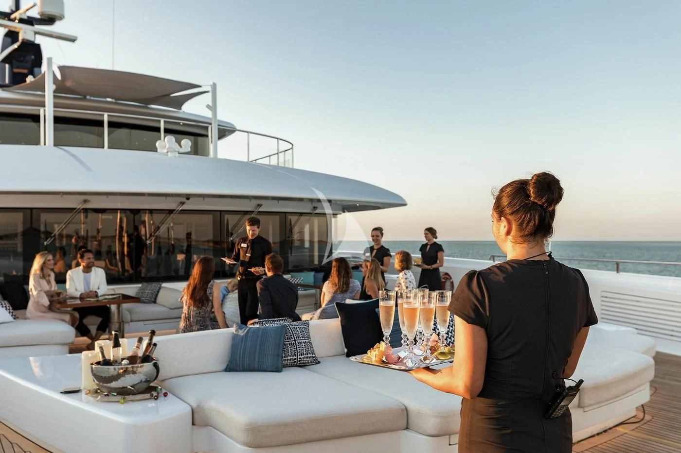 a group of people sitting around a table outside aboard STARBURST IV Yacht for Charter