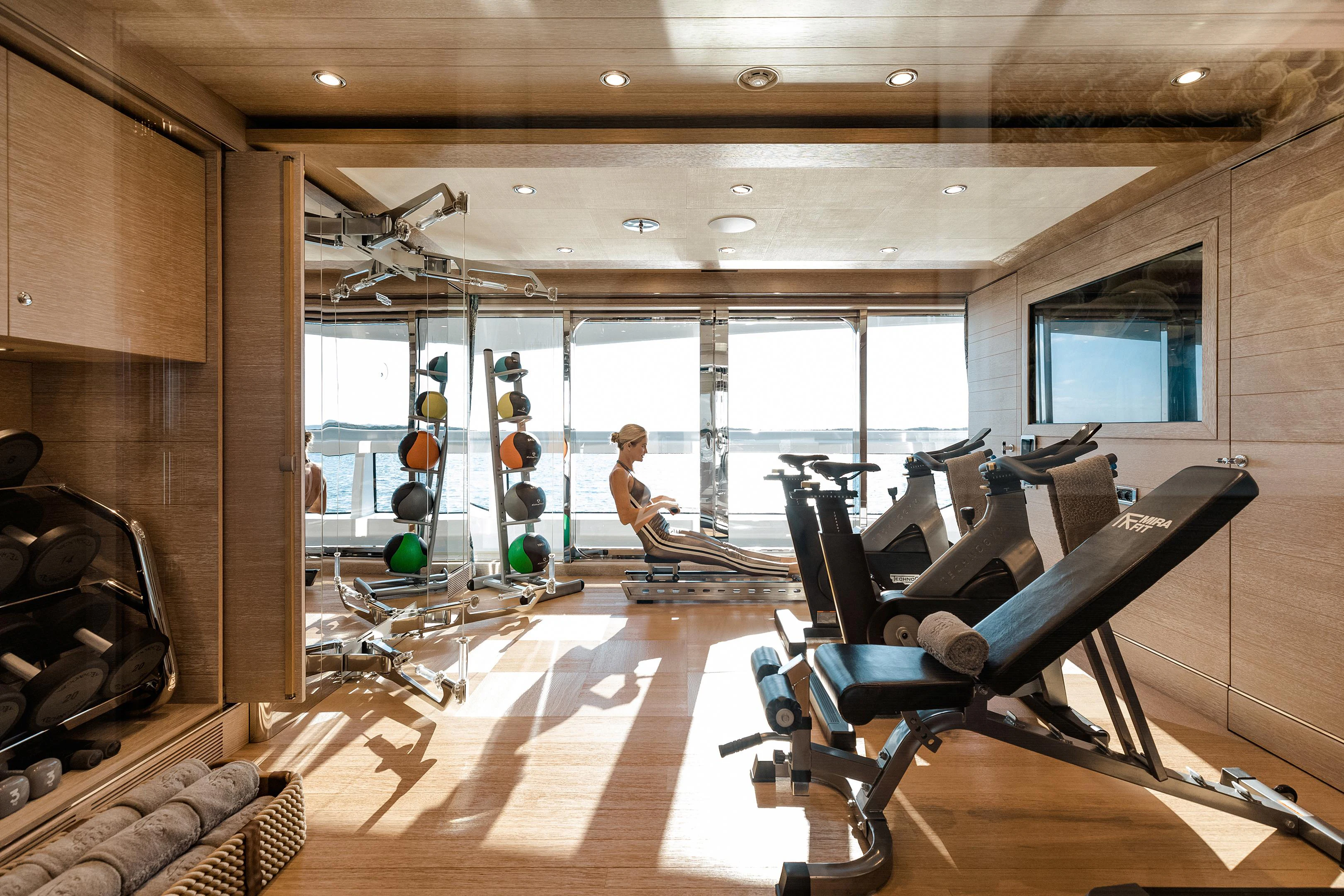 a person working in a gym aboard STARBURST IV Yacht for Charter