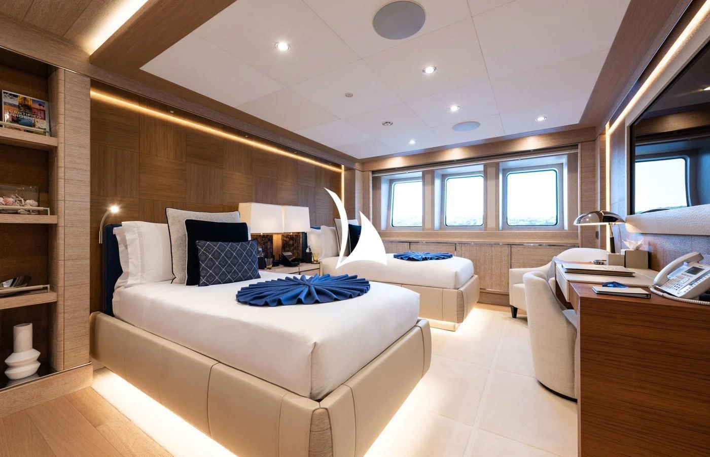 a room with a bed and a desk aboard STARBURST IV Yacht for Charter