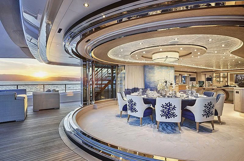 a large room with a table and chairs aboard STARBURST IV Yacht for Charter
