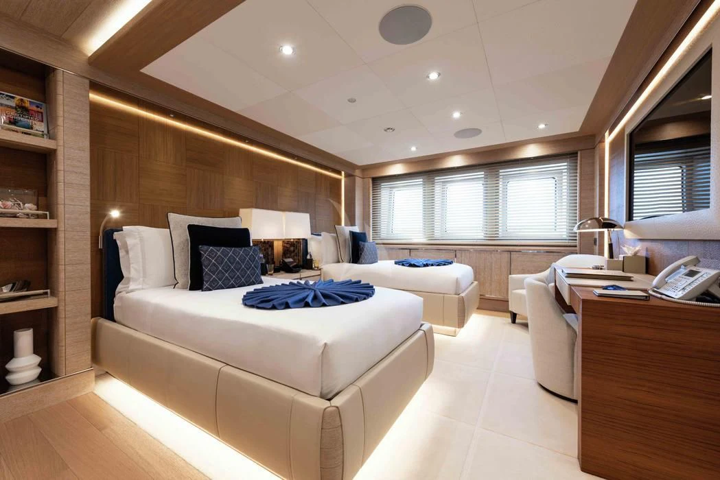 a room with a bed and a desk aboard STARBURST IV Yacht for Charter