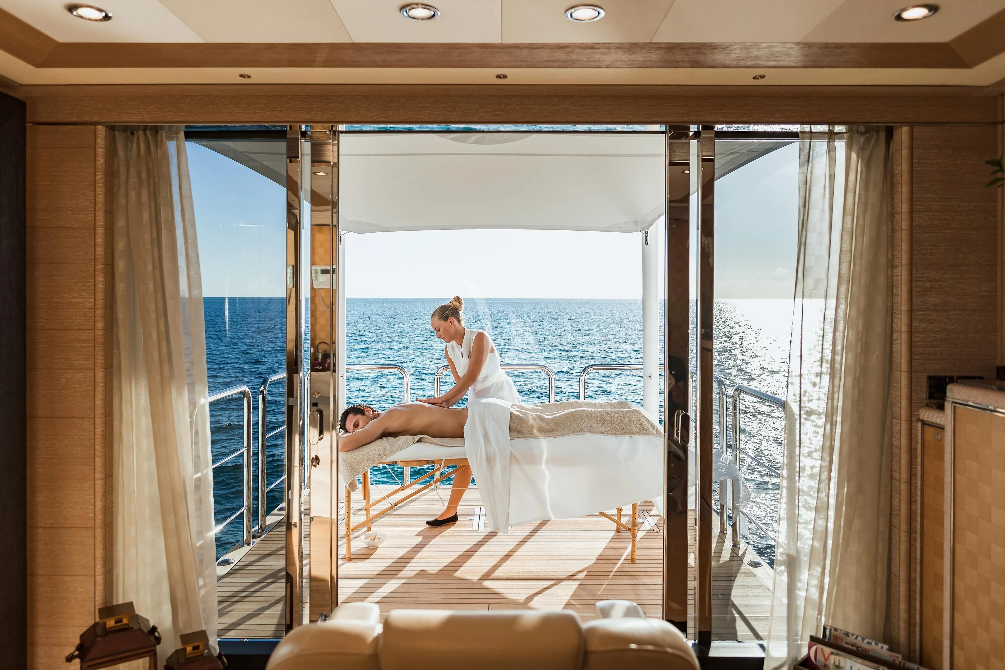 a person sitting on a white bed aboard STARBURST IV Yacht for Charter