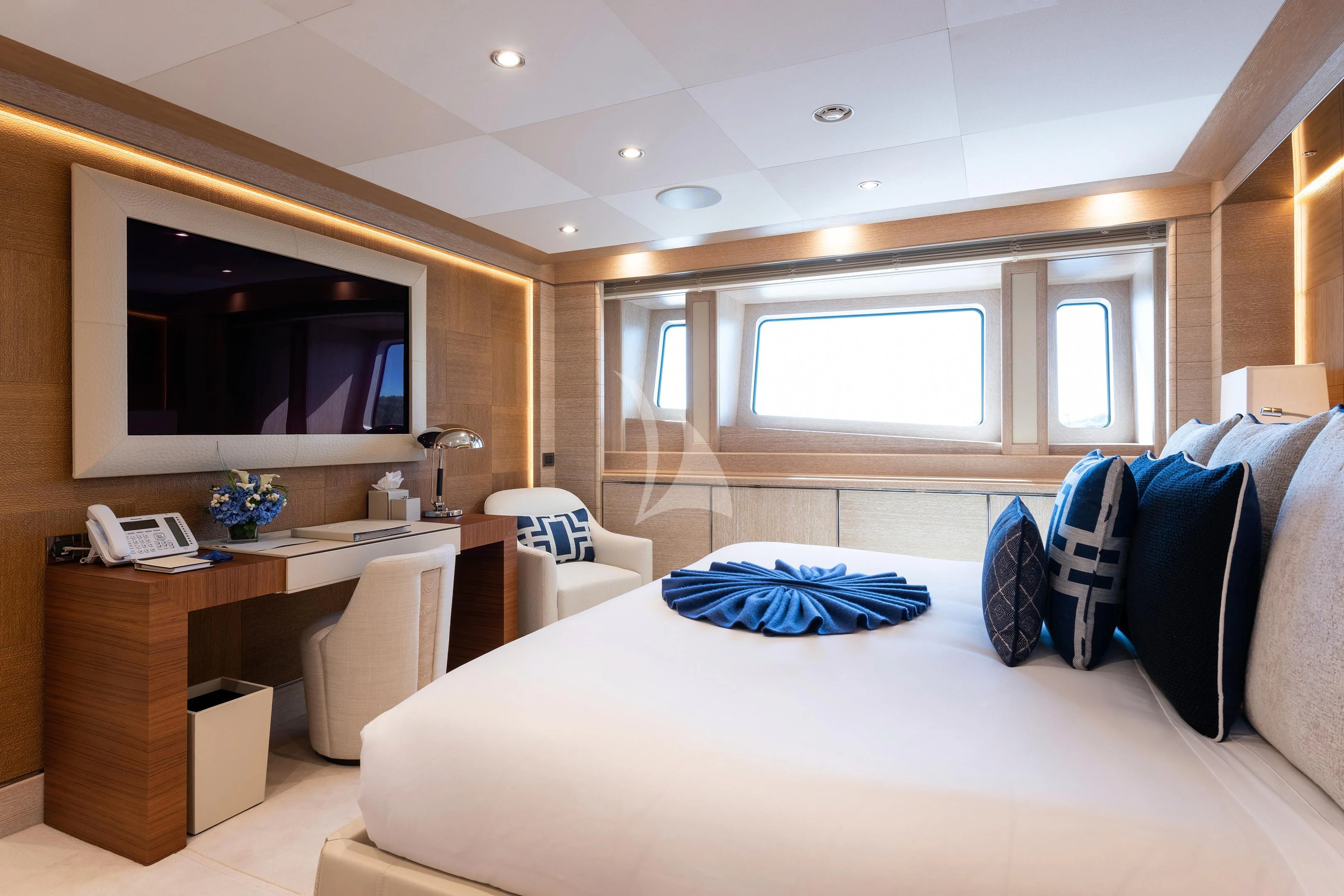 a bedroom with a large bed and a tv aboard STARBURST IV Yacht for Charter