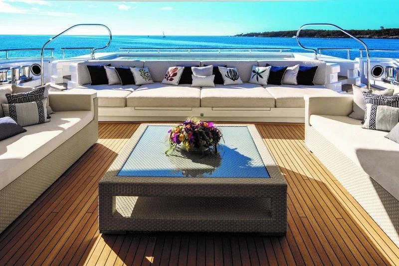 a deck with a large bed and a pool aboard STARBURST IV Yacht for Charter