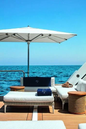 a lounge chair under an umbrella aboard STARBURST IV Yacht for Charter