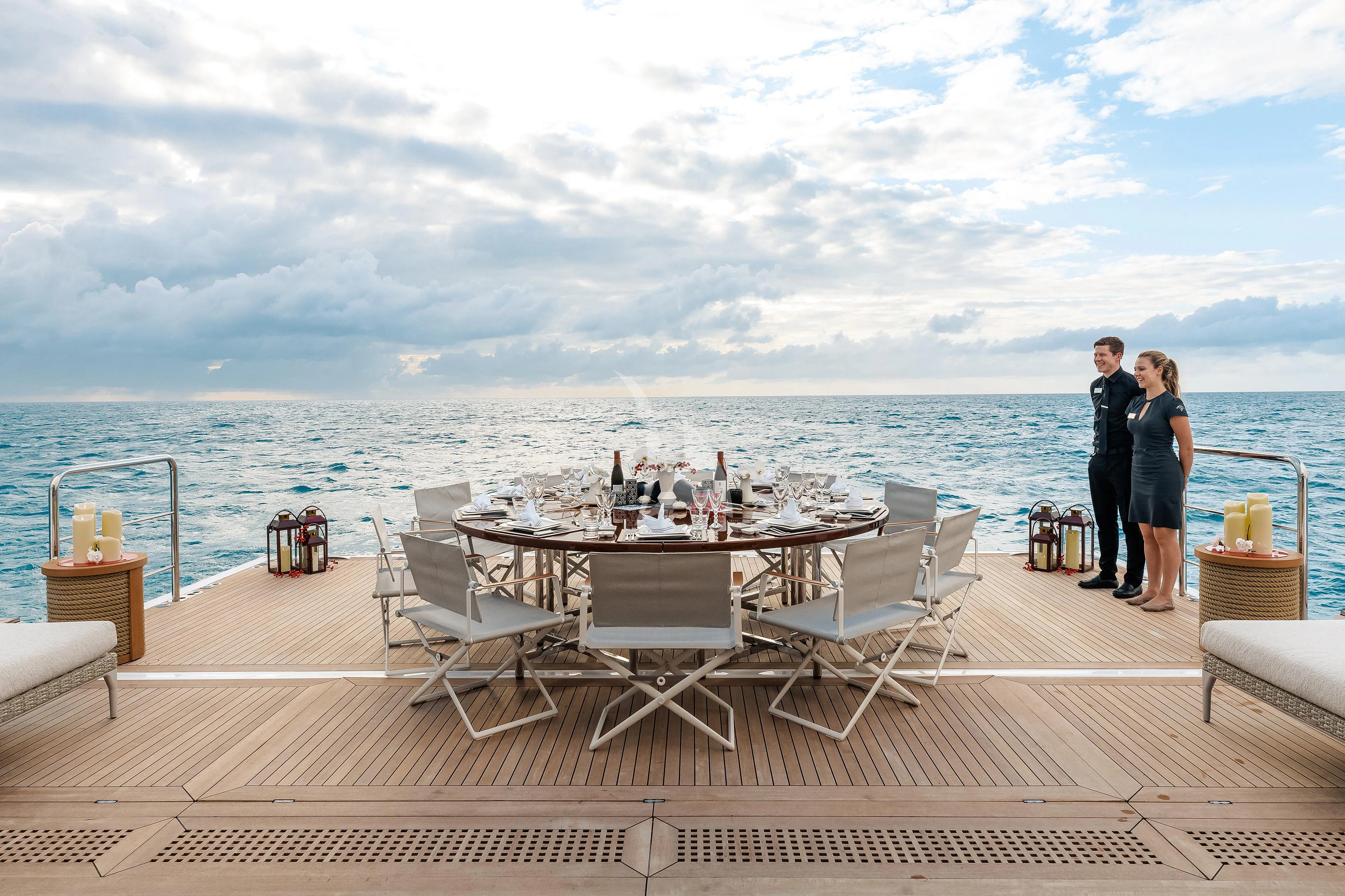 a couple of people standing on a deck overlooking the ocean aboard STARBURST IV Yacht for Charter