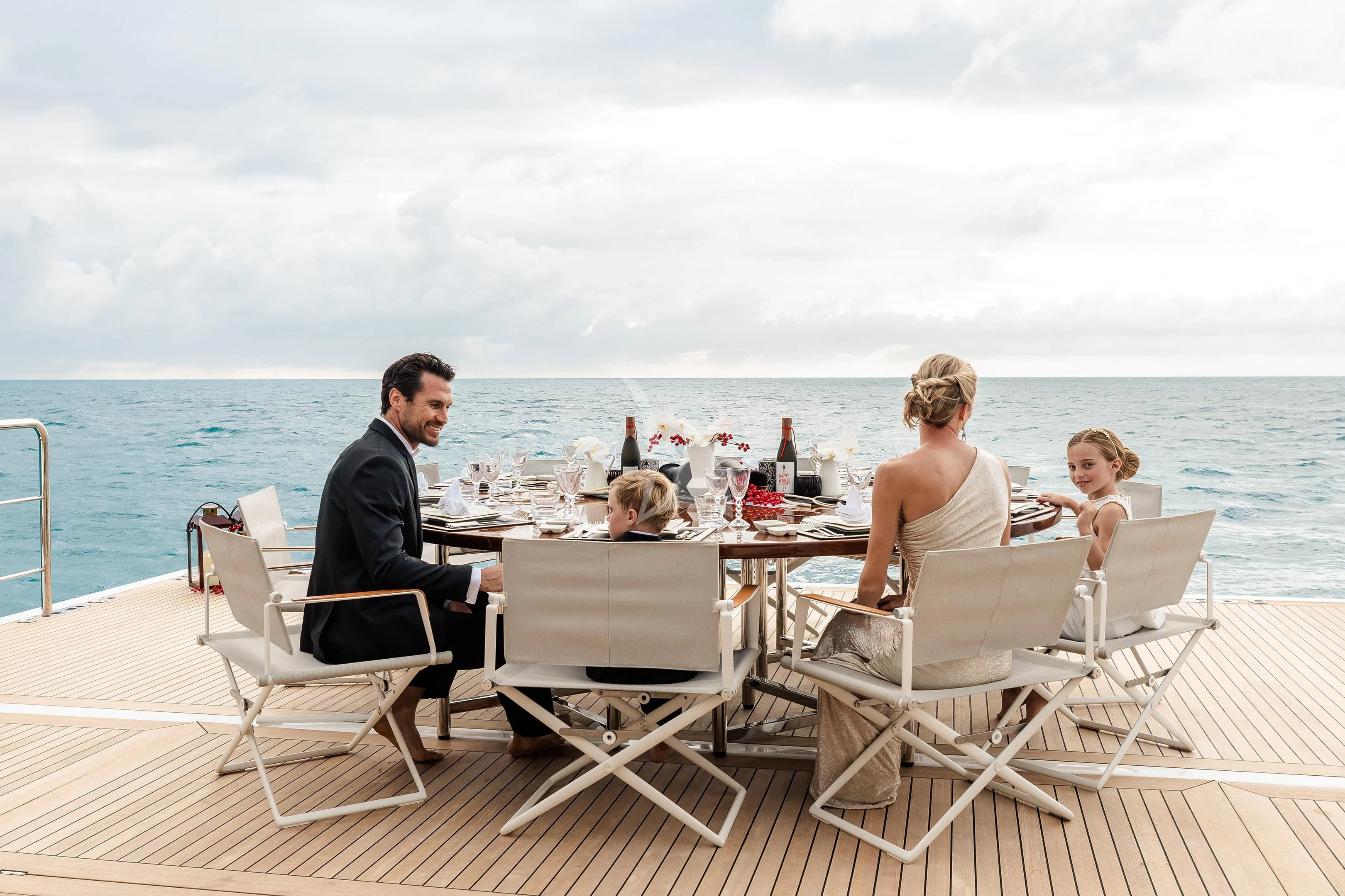 a group of people sitting on a deck on a boat aboard STARBURST IV Yacht for Charter