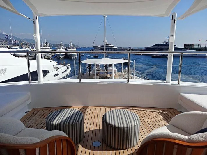 a deck with chairs and tables on it aboard STARBURST IV Yacht for Charter
