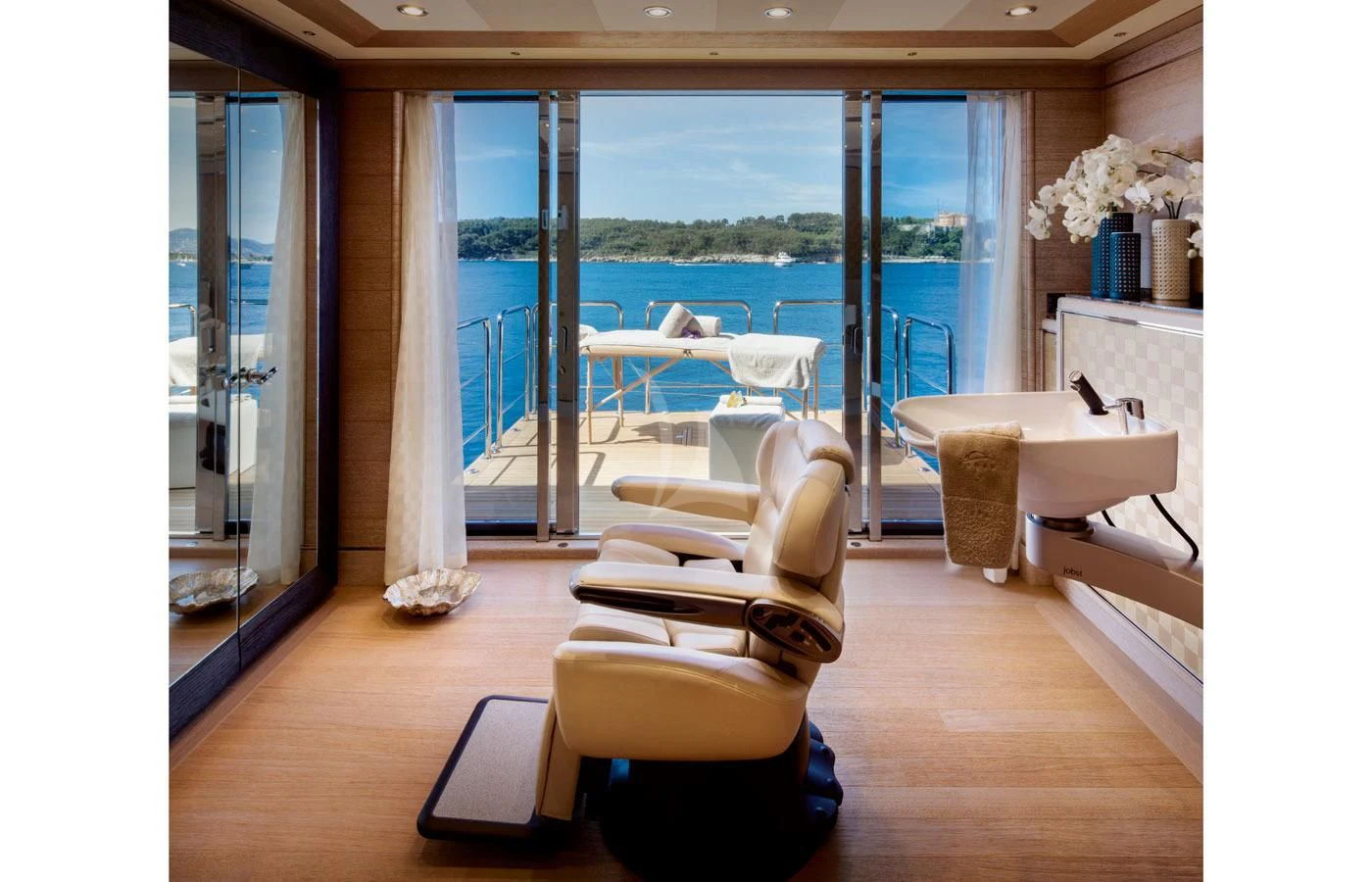 a room with a view of the ocean and a boat aboard STARBURST IV Yacht for Charter
