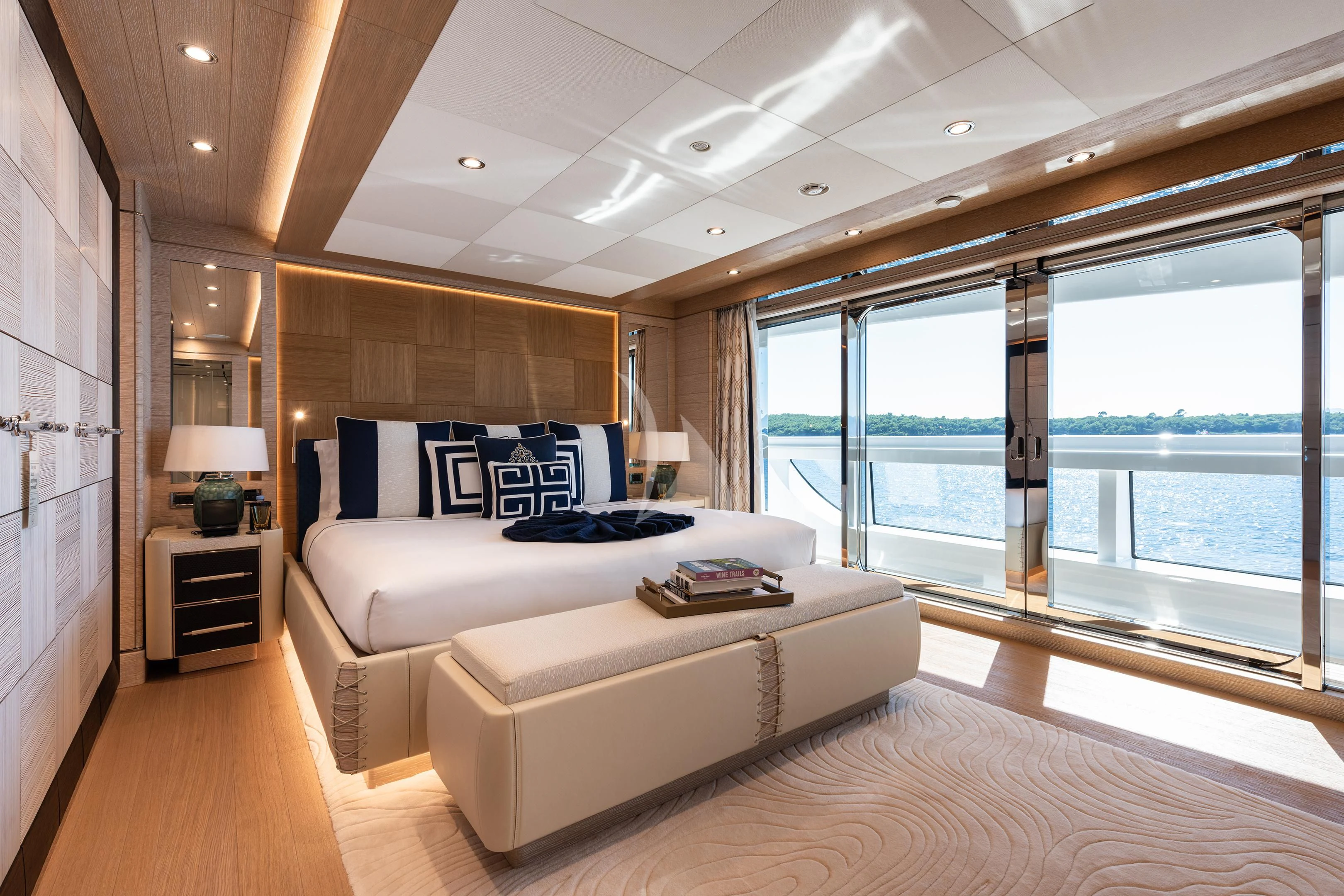 a large modern bedroom with a large window aboard STARBURST IV Yacht for Charter