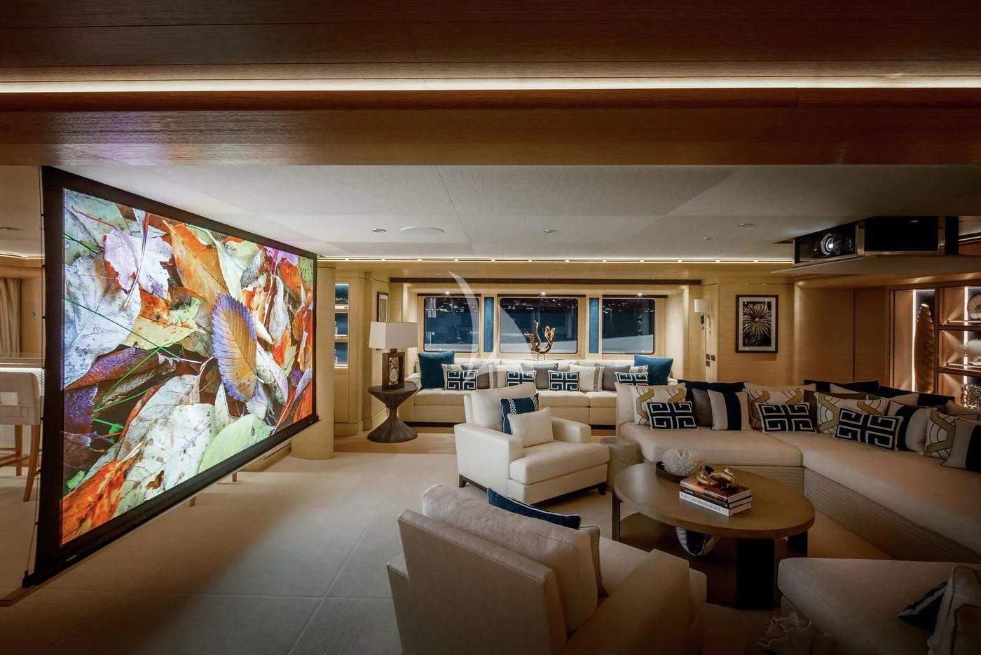 a living room with a large screen aboard STARBURST IV Yacht for Charter