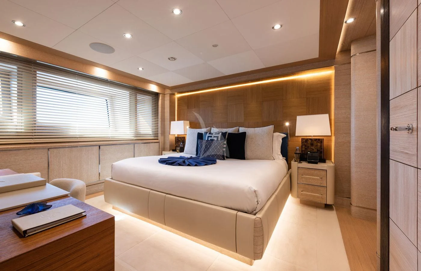 a room with a bed and a desk aboard STARBURST IV Yacht for Charter