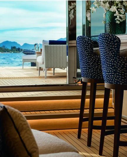 a deck with chairs and a body of water in the background aboard STARBURST IV Yacht for Charter
