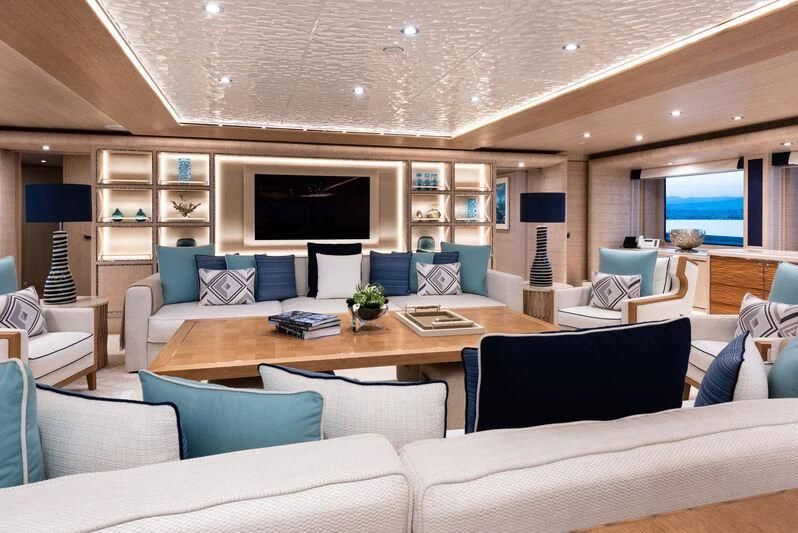 a living room with a large sofa and a table aboard STARBURST IV Yacht for Charter