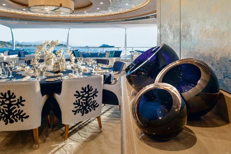 a table with a glass ball and a large round glass ball on it aboard STARBURST IV Yacht for Charter