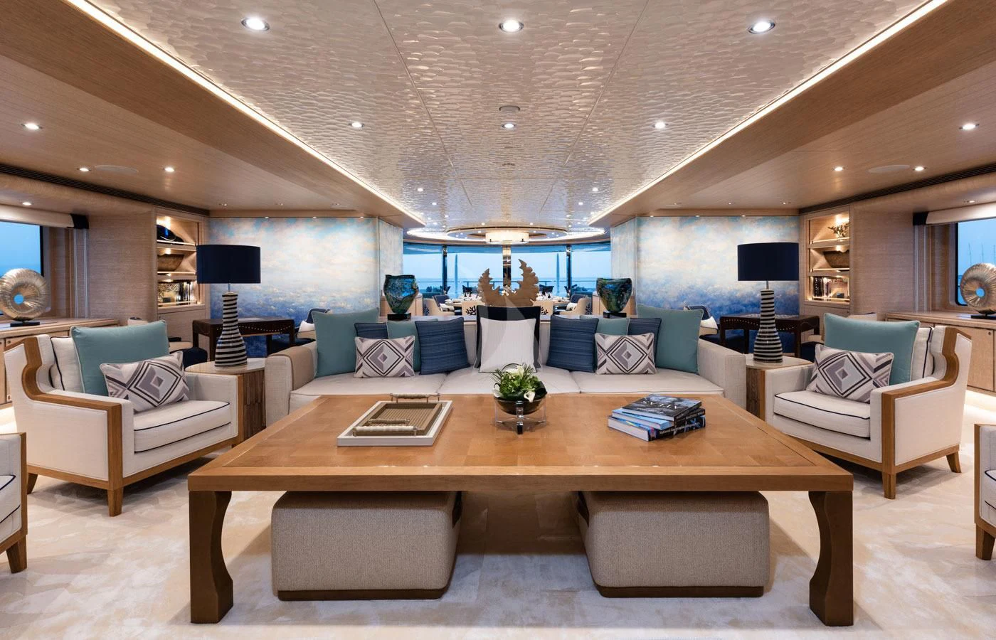 a living room with a large table and couches aboard STARBURST IV Yacht for Charter