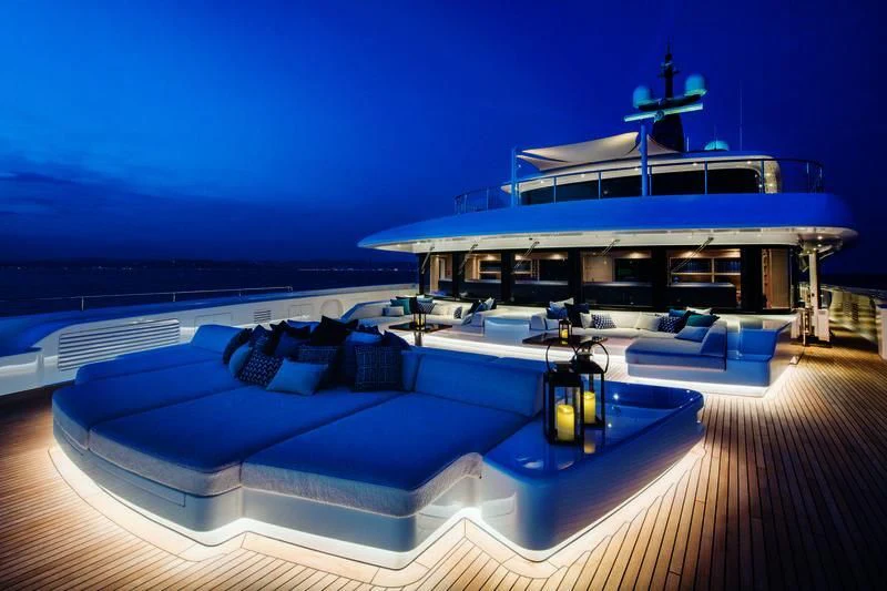 a large pool with a deck and a deck and a boat on the water aboard STARBURST IV Yacht for Charter