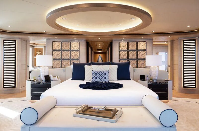 a large bed with a white bed spread aboard STARBURST IV Yacht for Charter