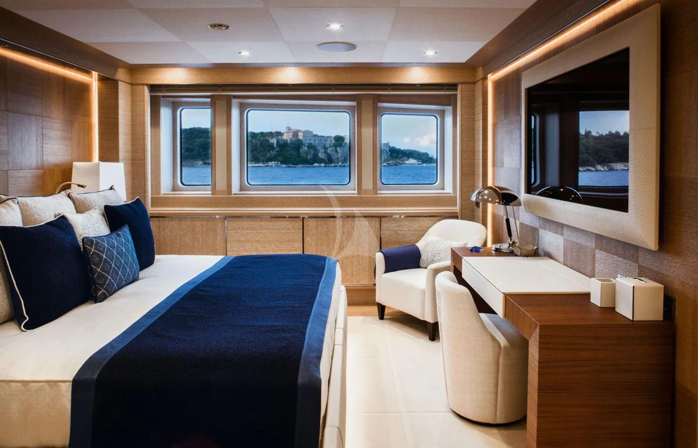 a room with a bed and a desk aboard STARBURST IV Yacht for Charter