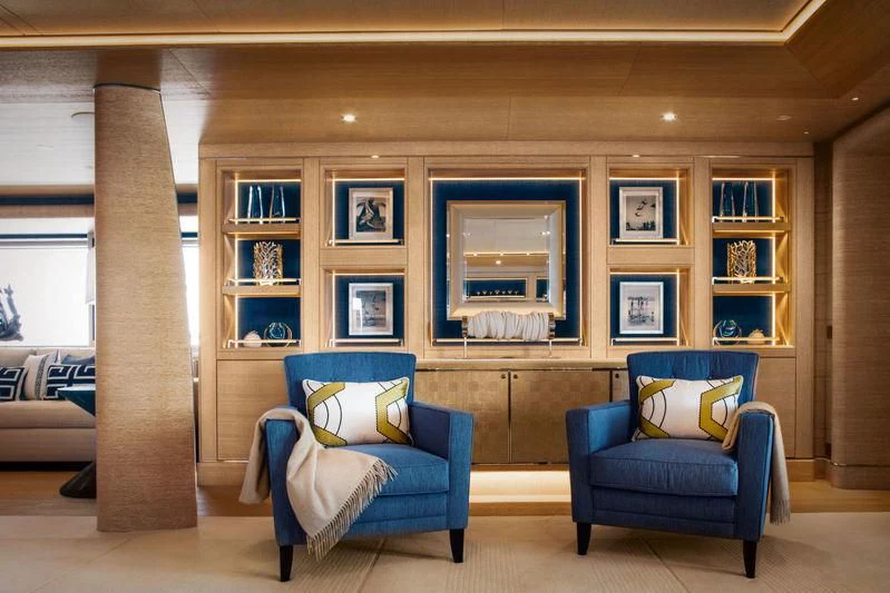 a room with a blue chair and a blue chair aboard STARBURST IV Yacht for Charter