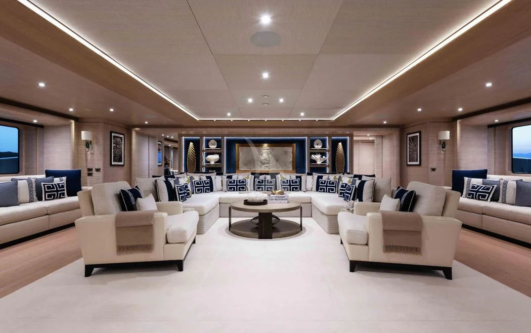 a large living room with white couches and a large screen aboard STARBURST IV Yacht for Charter