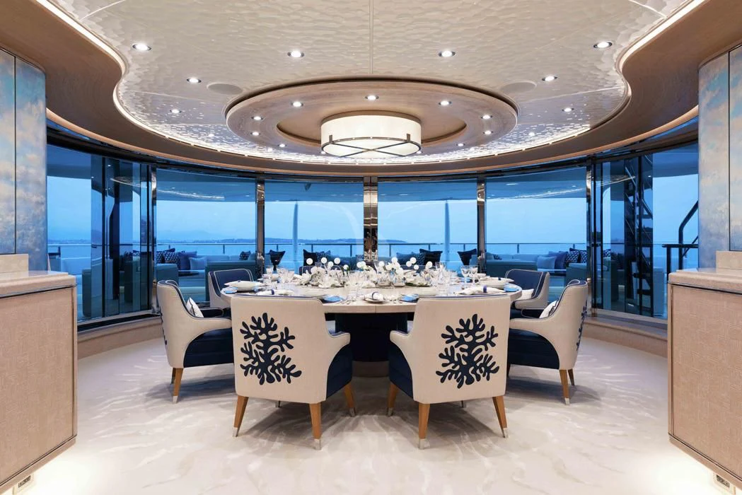 a room with a table chairs and a large glass ceiling aboard STARBURST IV Yacht for Charter