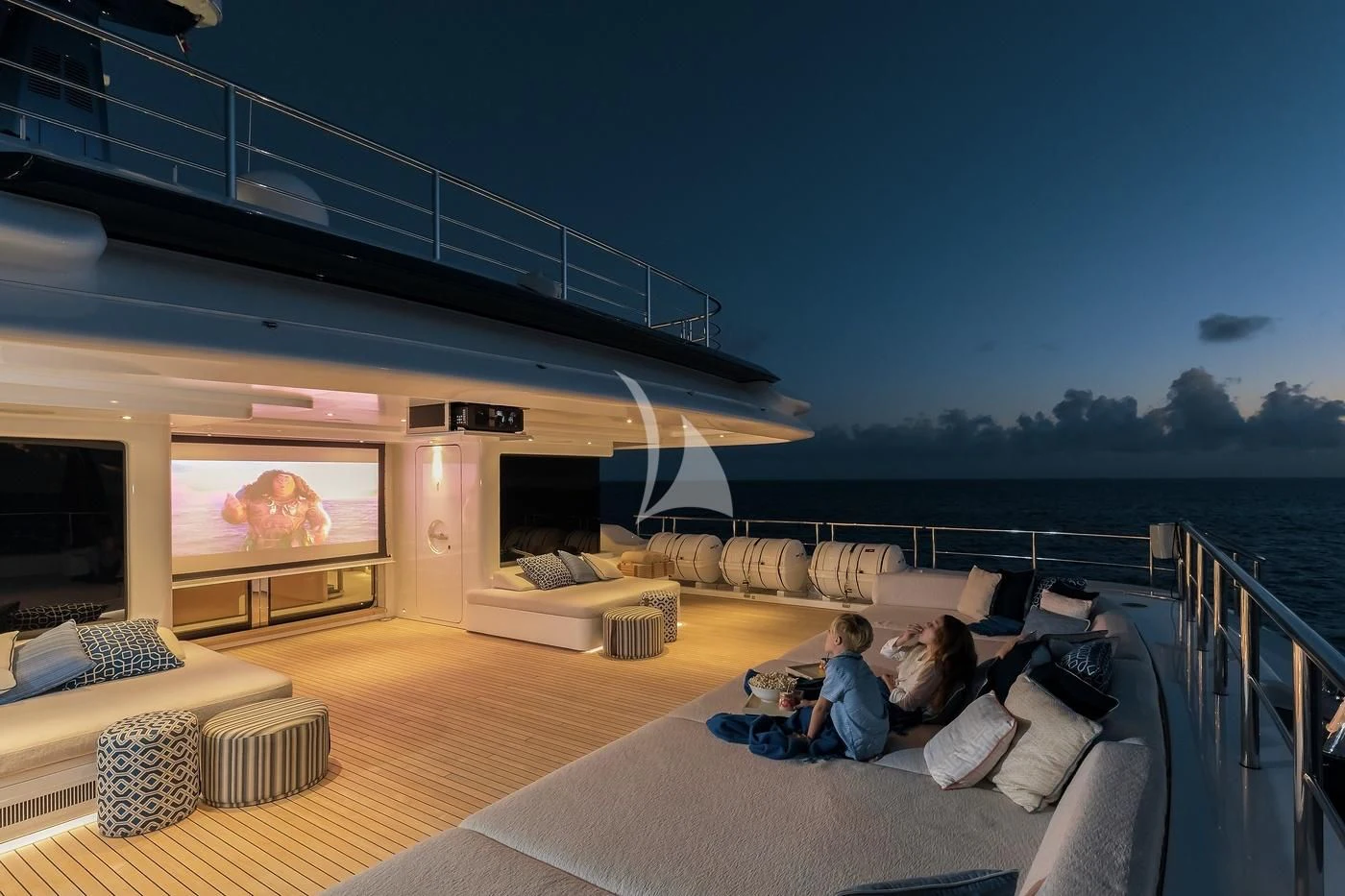 a couple of people watching a television aboard STARBURST IV Yacht for Charter