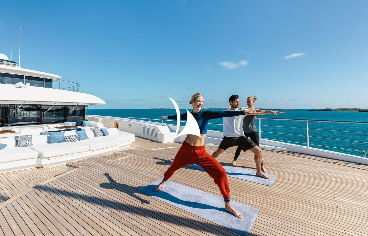 a group of people jumping on a dock with boats in the background aboard STARBURST IV Yacht for Charter