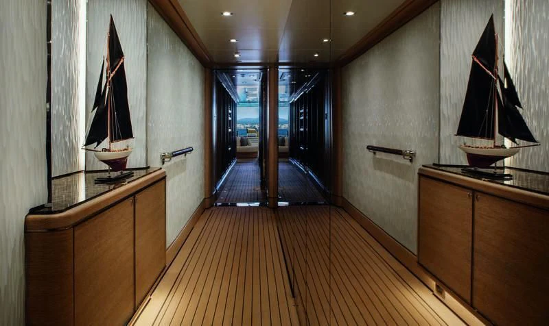 a room with a wood floor and a wood floor with a black framed painting on it aboard STARBURST IV Yacht for Charter