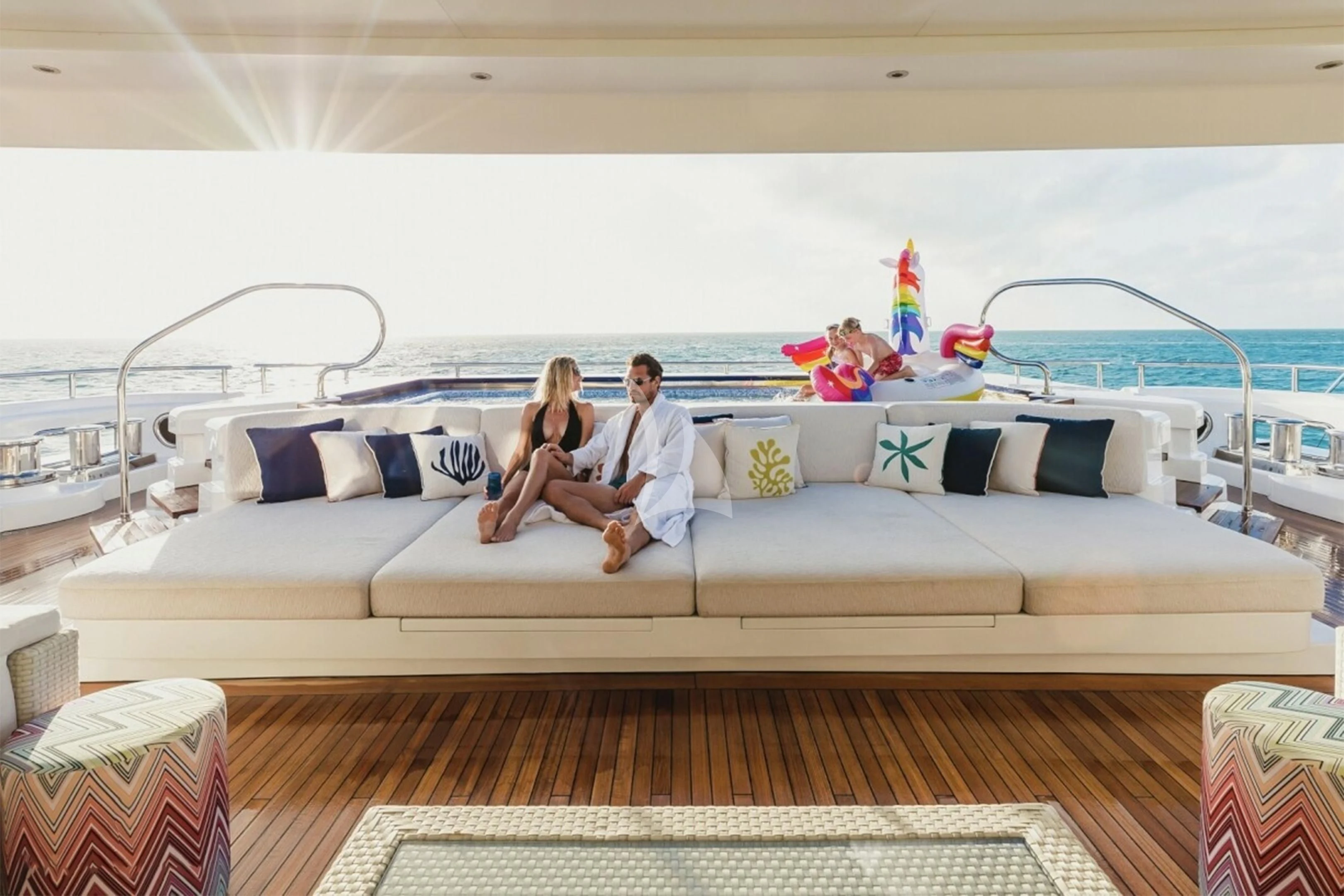 a man and woman sitting on a couch on a boat aboard STARBURST IV Yacht for Charter